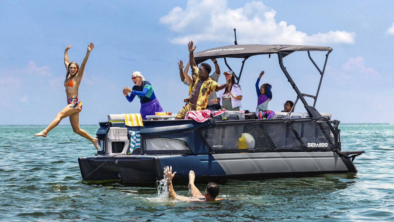 A family having fun on a Sea-Doo Switch pontoon boat