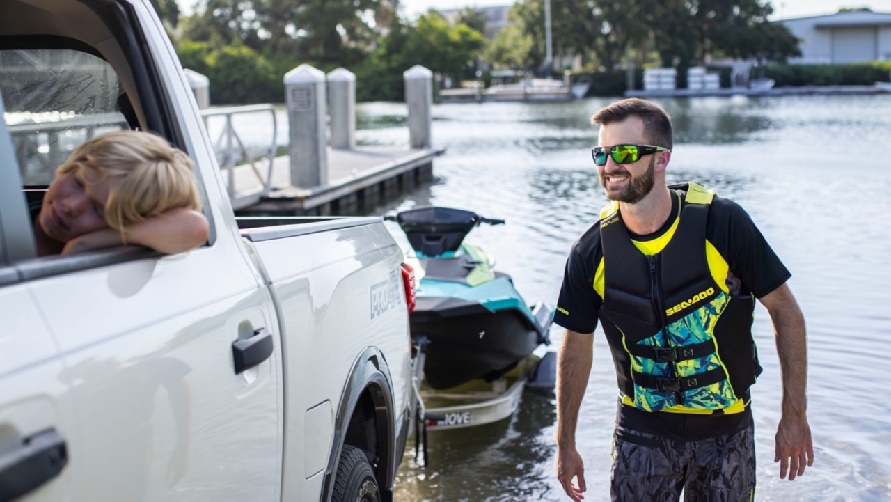 Man taking his Sea-Doo out of the water with his car
