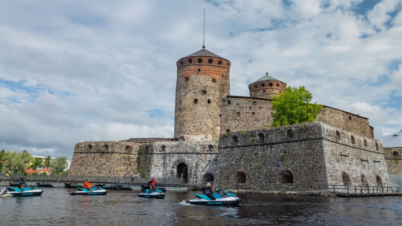 Sea-Doos passing in front of a Castle