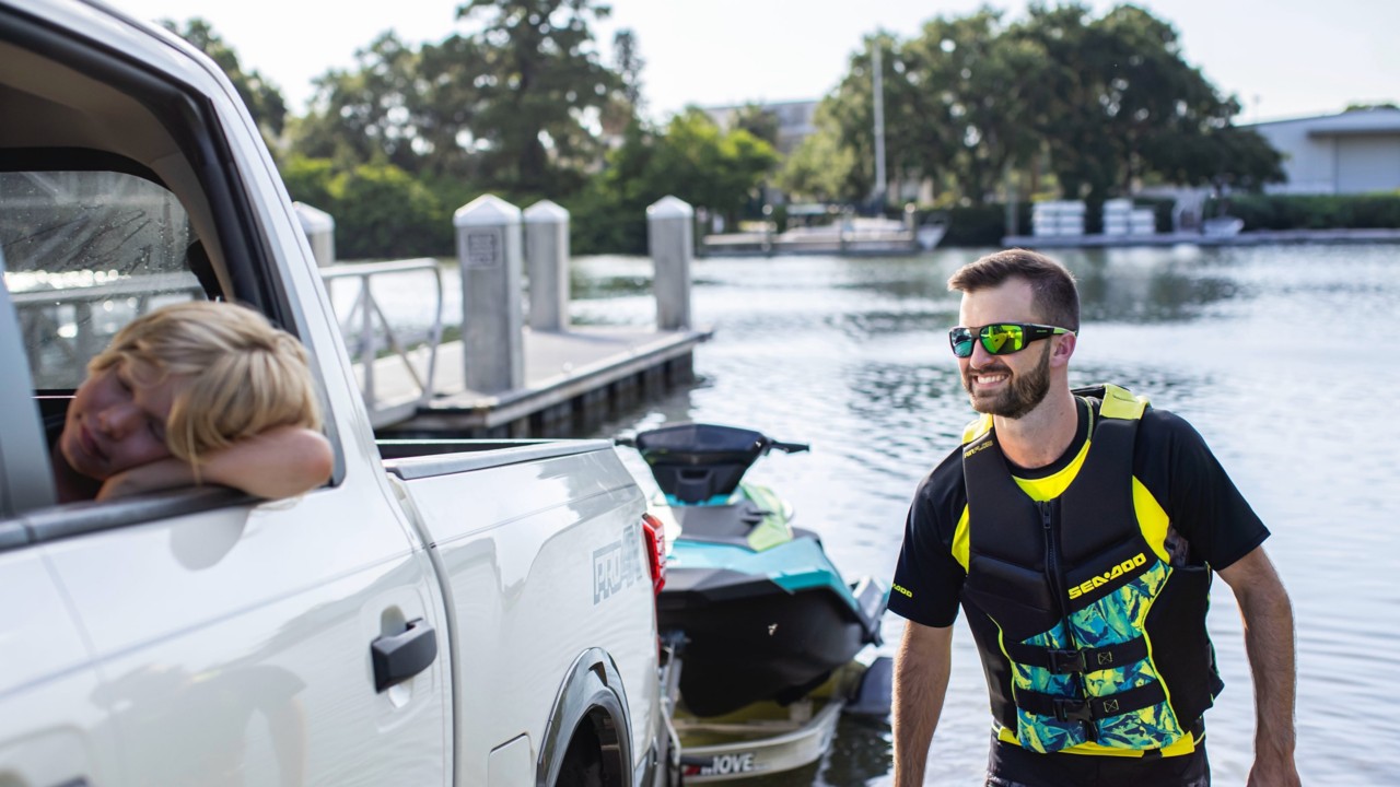 Man taking his Sea-Doo out of the water with his car